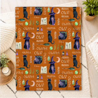 Personalized Olivia Halloween fleece blanket featuring black cats witch hats cauldrons and magic spell book pattern.