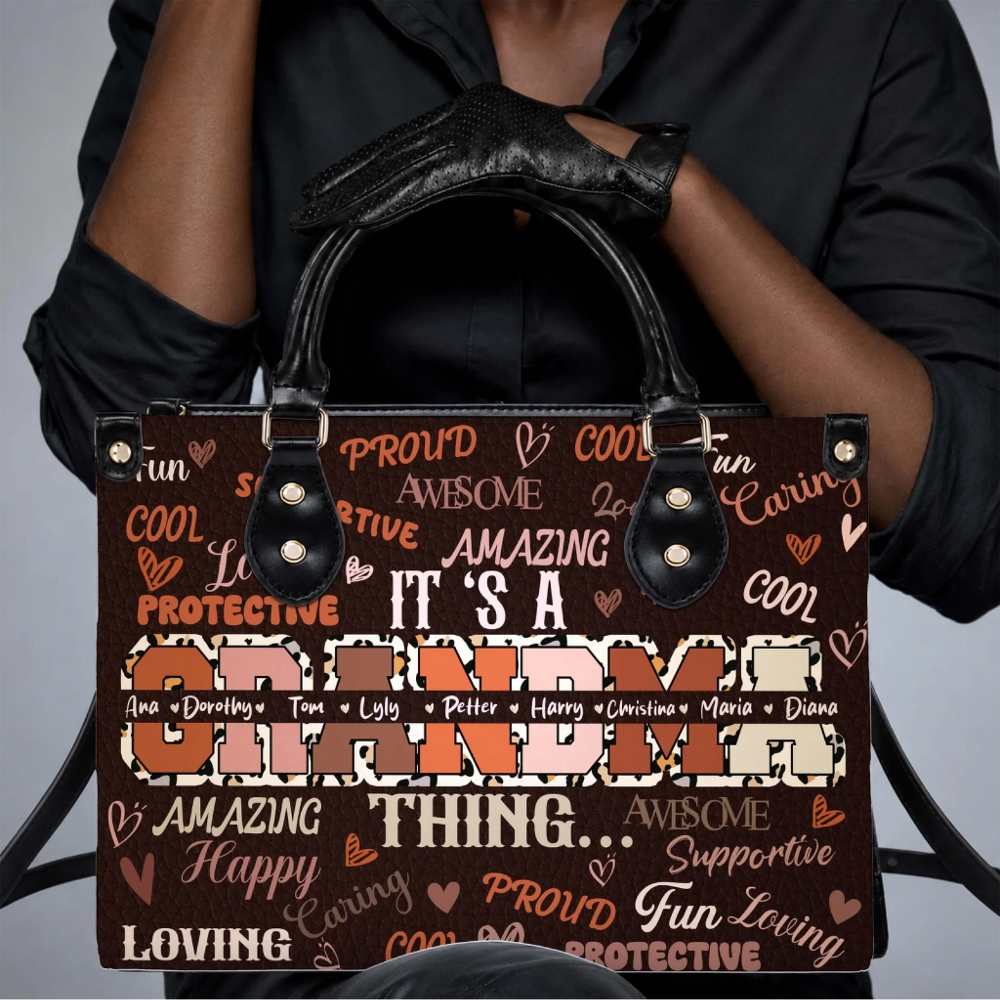 Handbag with custom grandma text and names featuring a trendy leopard pattern, held by a woman in black clothes.