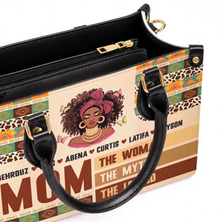 Close up of a custom leather tote bag for mom featuring an African American woman illustration, butterfly accents, and children names.