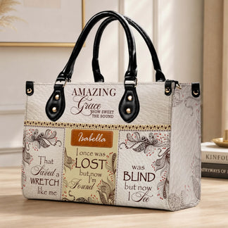 Elegant personalized handbag displaying the Amazing Grace song lyrics and Isabella for a faith-filled accessory.