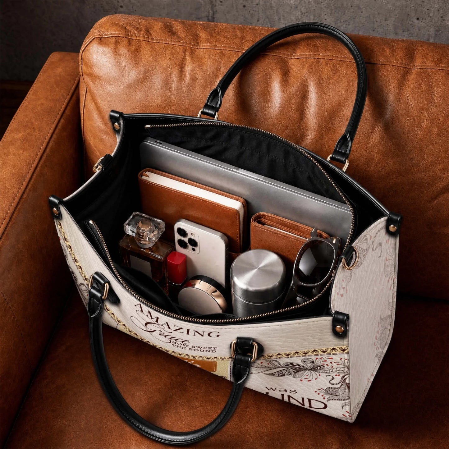 Spacious interior of a custom Amazing Grace tote bag organized with a laptop, notebook, phone, and daily accessories.