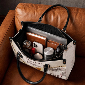 Spacious interior of a custom Amazing Grace tote bag organized with a laptop, notebook, phone, and daily accessories.