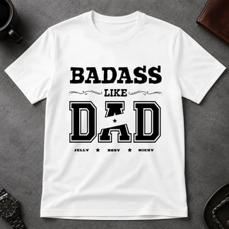 White t-shirt with 'BADASS LIKE DAD' text on a gray surface
