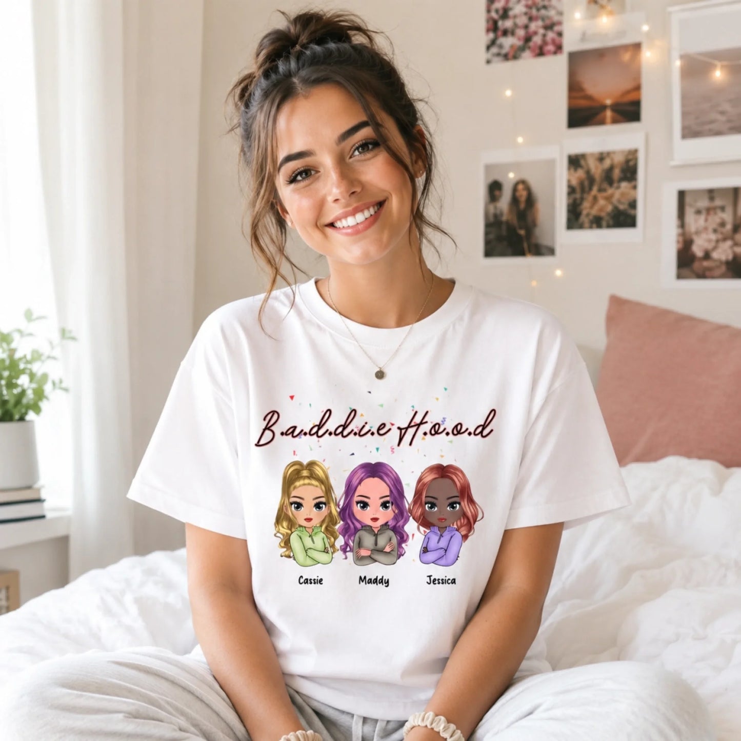 Woman wearing a white t-shirt with cartoon characters and text, sitting on a bed.