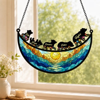 Hanging custom family bear suncatcher displayed in a sunny window, showing personalized bear names and mountain art.