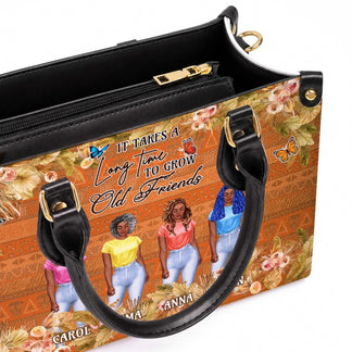Close up view of the customized best friend handbag showcasing the names Carol Emma Anna and Helen with floral and butterfly accents.