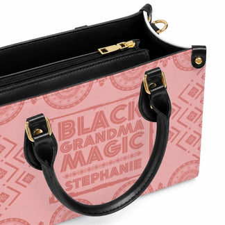 A close up view of the black zipper and leather handle details on a personalized Black Grandma Magic handbag.