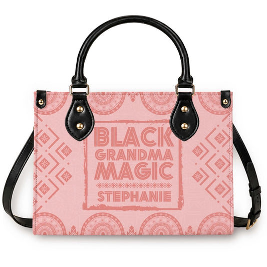 A personalized pink tote bag with black handles featuring the Black Grandma Magic design customized with the name Stephanie.