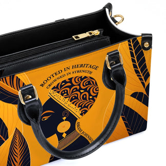 Custom PU leather handbag featuring a Black woman portrait with the text Rooted in Heritage Crowned in Strength.