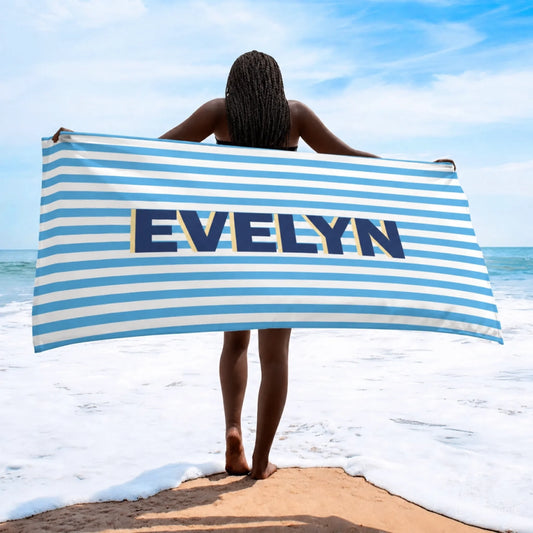 A personalized beach towel featuring blue and white stripes with the custom name Evelyn displayed prominently.