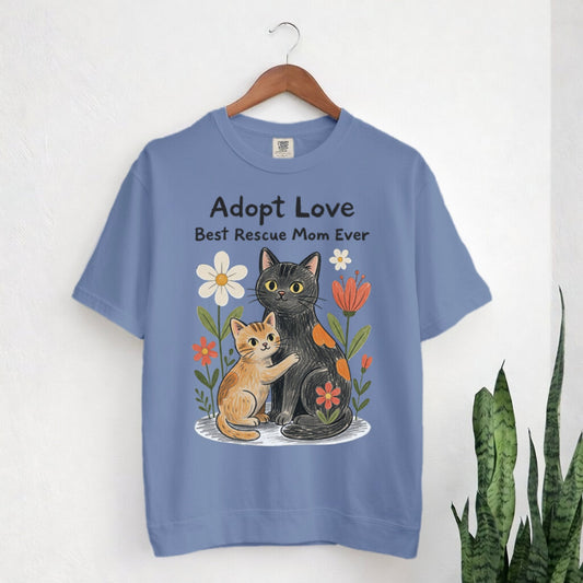 Blue t-shirt with cat illustration and text 'Adopt Love Best Rescue Mom Ever' on a white background.