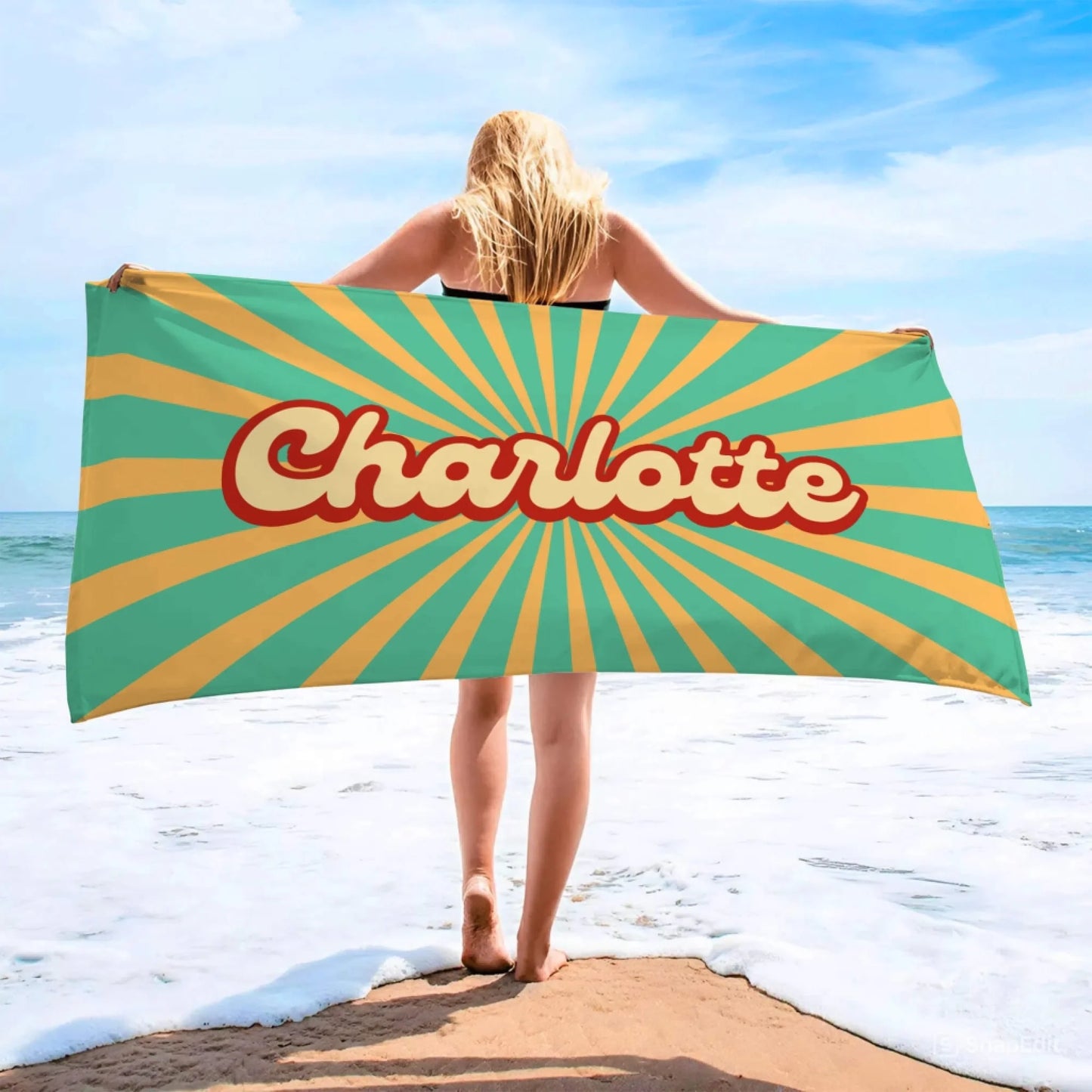 Personalized Charlotte beach towel with a vibrant retro sunburst print perfect for a beach day or summer vacation.