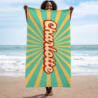 Vertical retro sunburst beach towel personalized with the name Charlotte for a fun beach day or pool party.