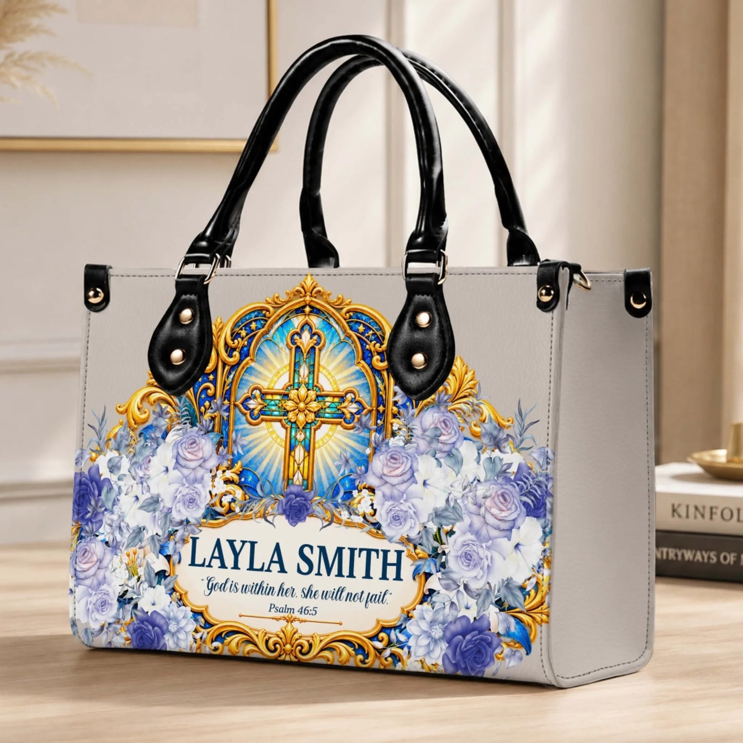 A custom floral and cross print PU leather handbag personalized with the name Layla Smith and a bible verse quote.