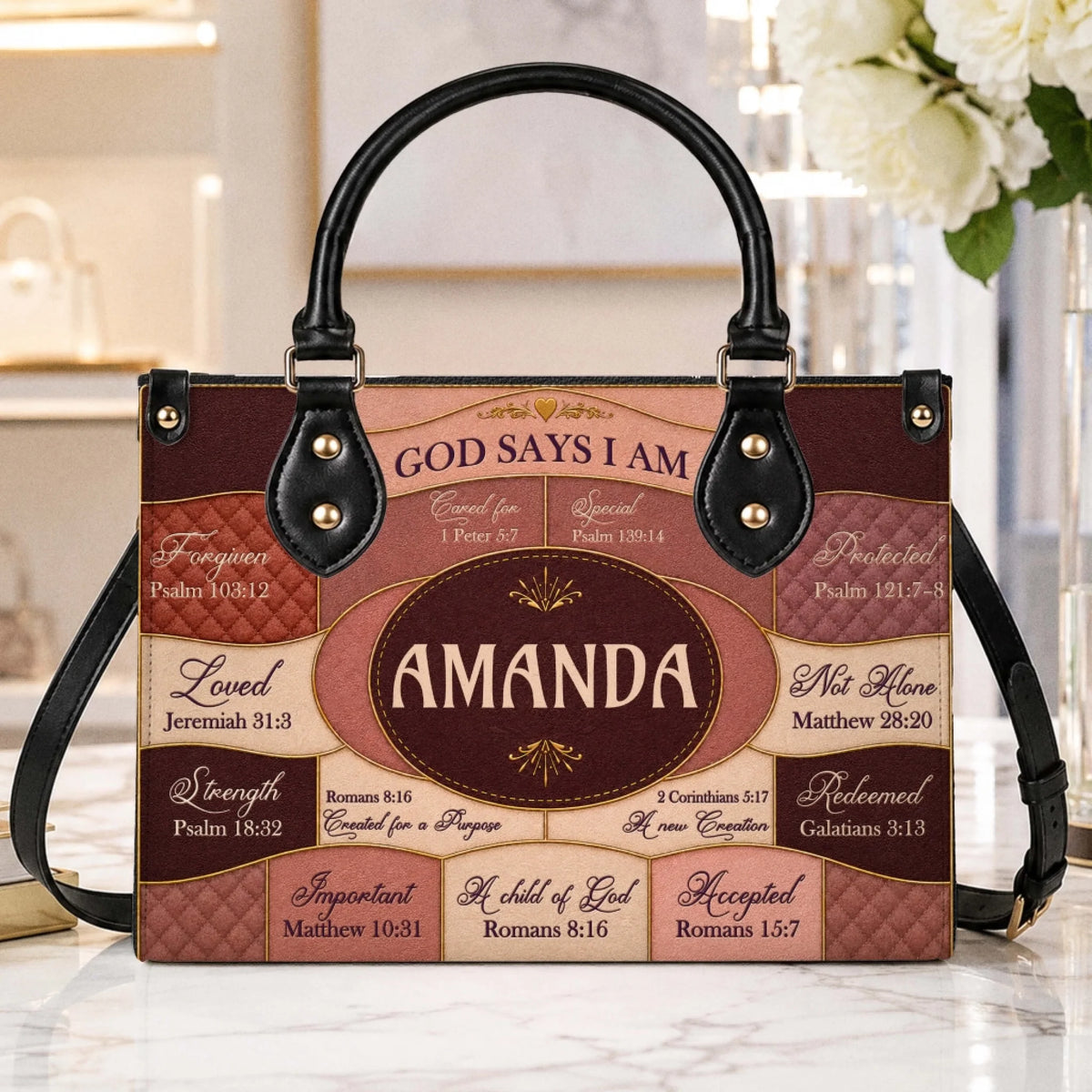 Detailed view of a personalized handbag featuring scripture verses and the name Amanda in an elegant, neutral color palette.