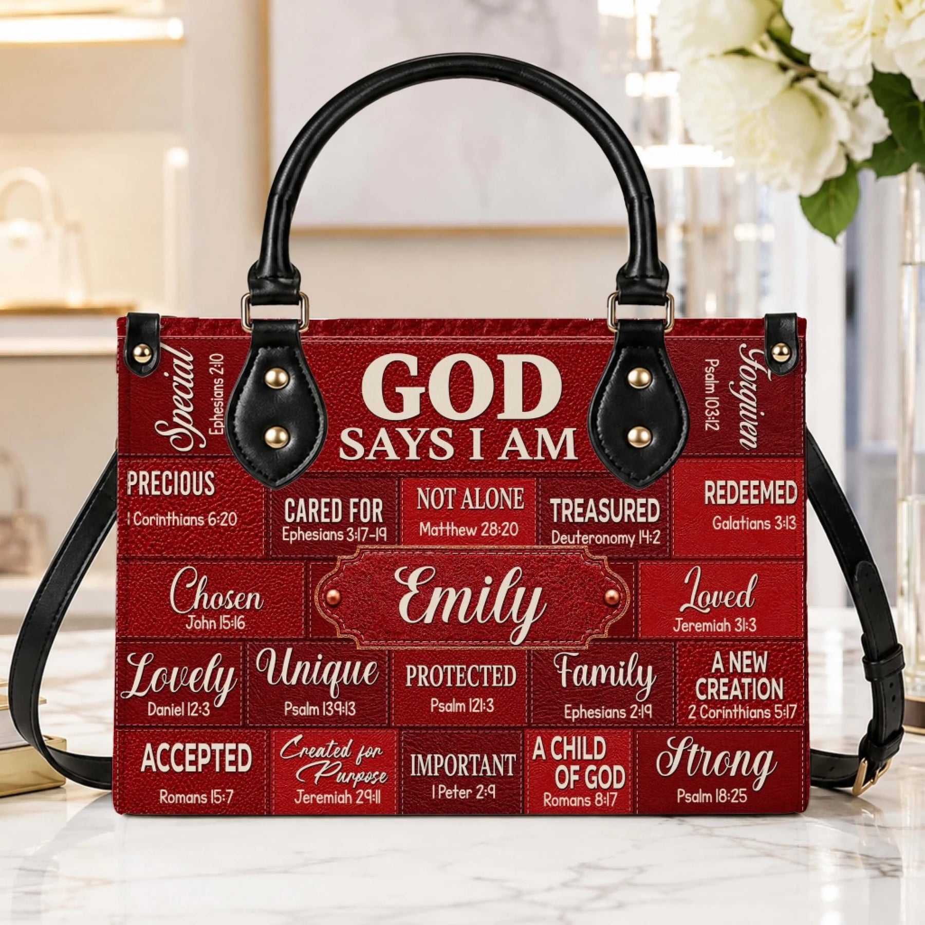 A high-quality personalized red leather bag decorated with scripture, featuring a custom name plaque for Emily.