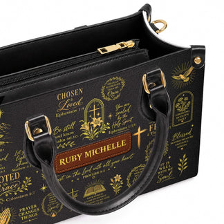 A personalized black PU leather handbag featuring elegant gold religious scripture quotes and a custom name label plate.