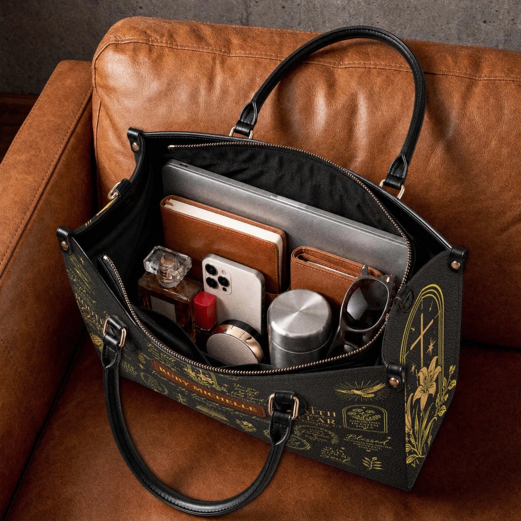 Spacious personalized leather tote bag featuring gold bible verses and faith-based illustrations packed with daily essentials.