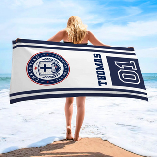 A personalized school spirit beach towel featuring the Christian School Academy logo, custom name, and jersey number.