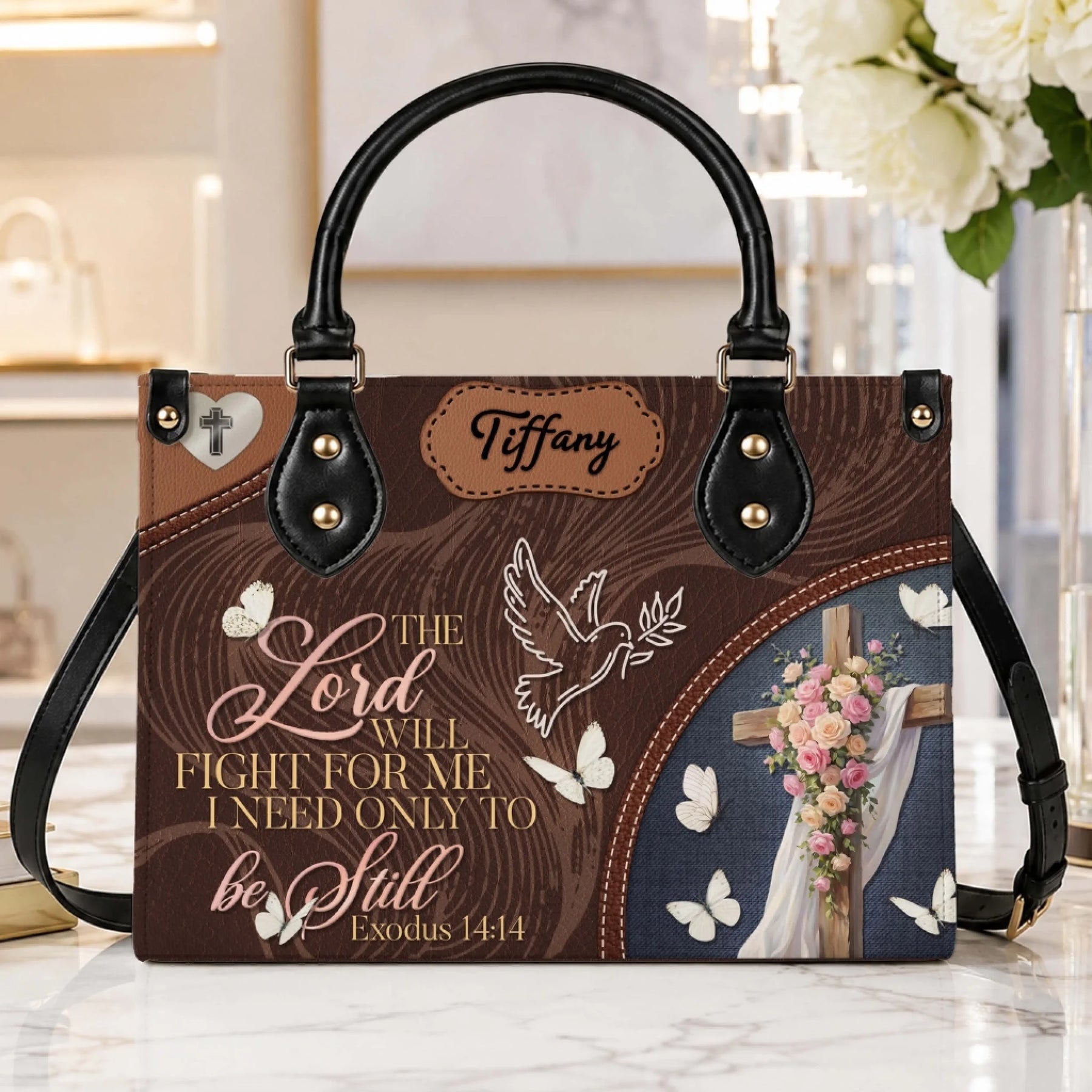 Personalized brown tote bag featuring a cross with flowers, butterflies, and the scripture quote Exodus 14 14 for faith.