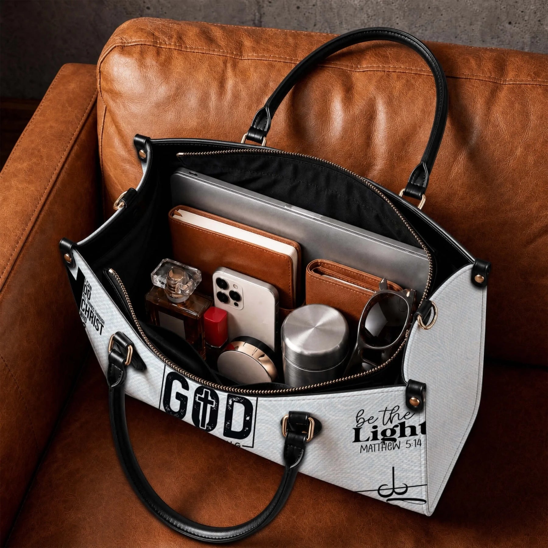 Spacious personalized Christian tote bag featuring religious quotes and symbols, shown filled with daily work essentials.