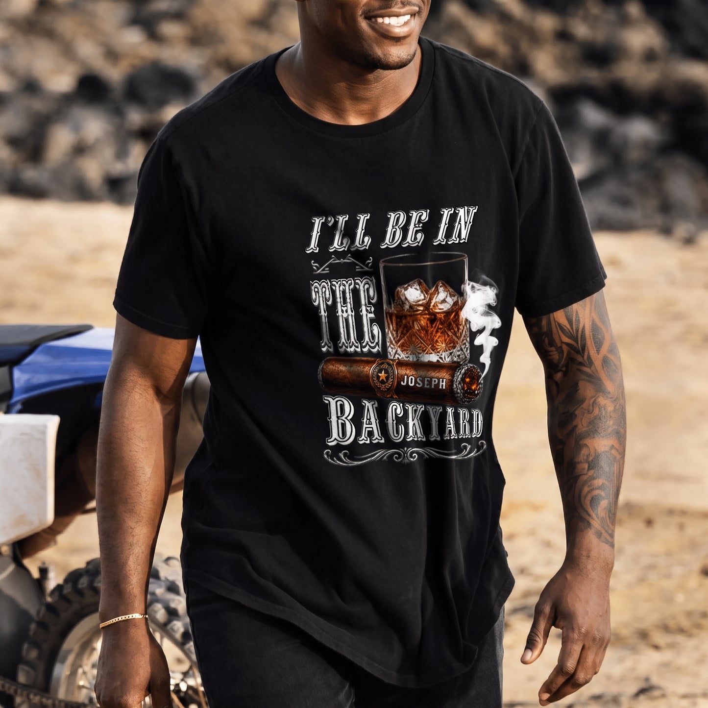 Casual men’s black t-shirt featuring a custom whiskey glass and cigar print with the personalized name Joseph.