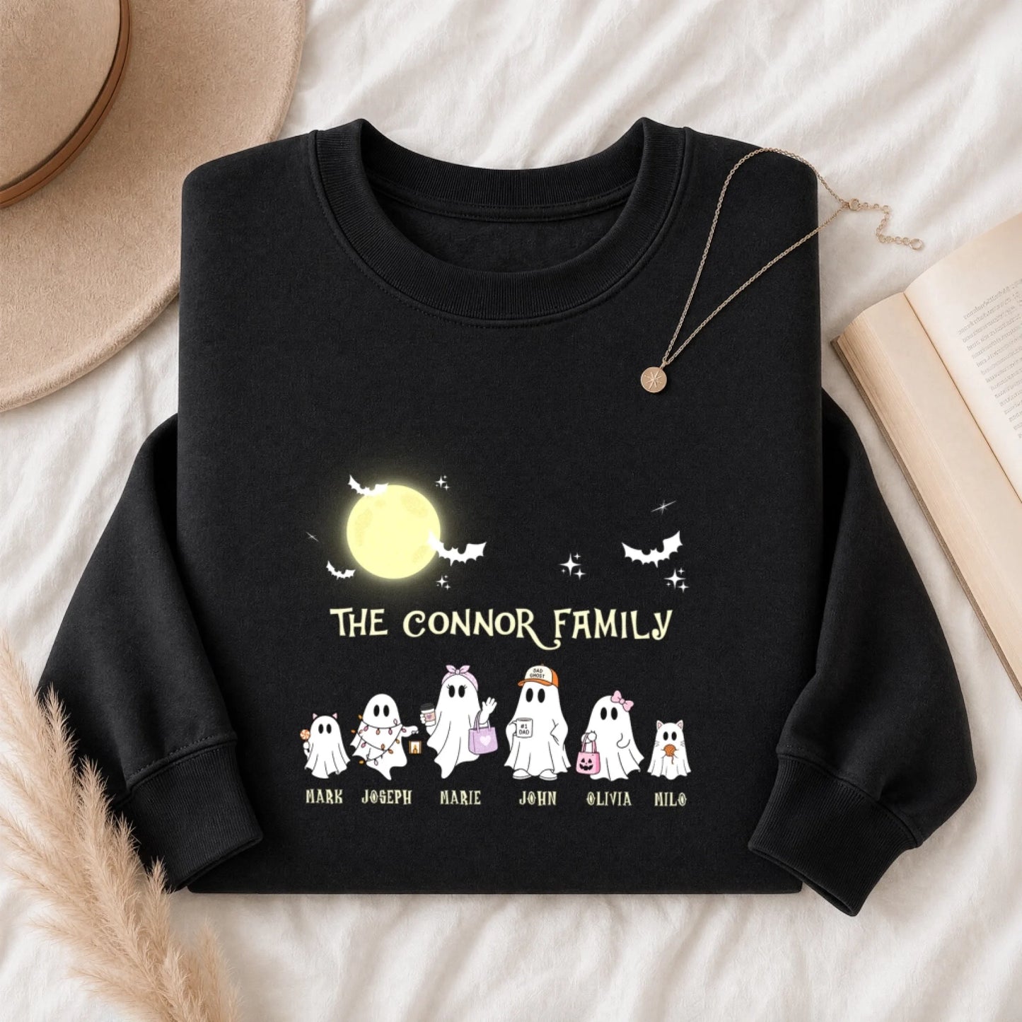 A black personalized Halloween sweatshirt featuring a custom ghost family illustration and printed family names.