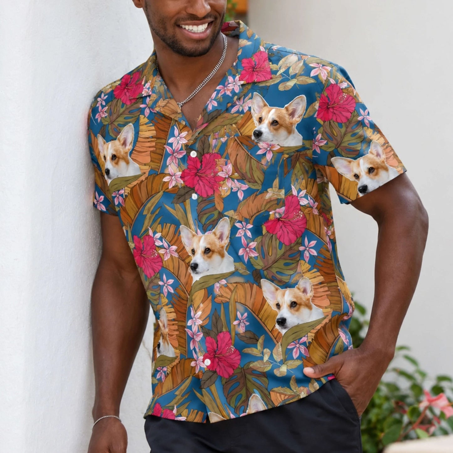 A man wearing a custom Hawaiian shirt featuring a personalized corgi face pattern with tropical flowers and palm leaves.