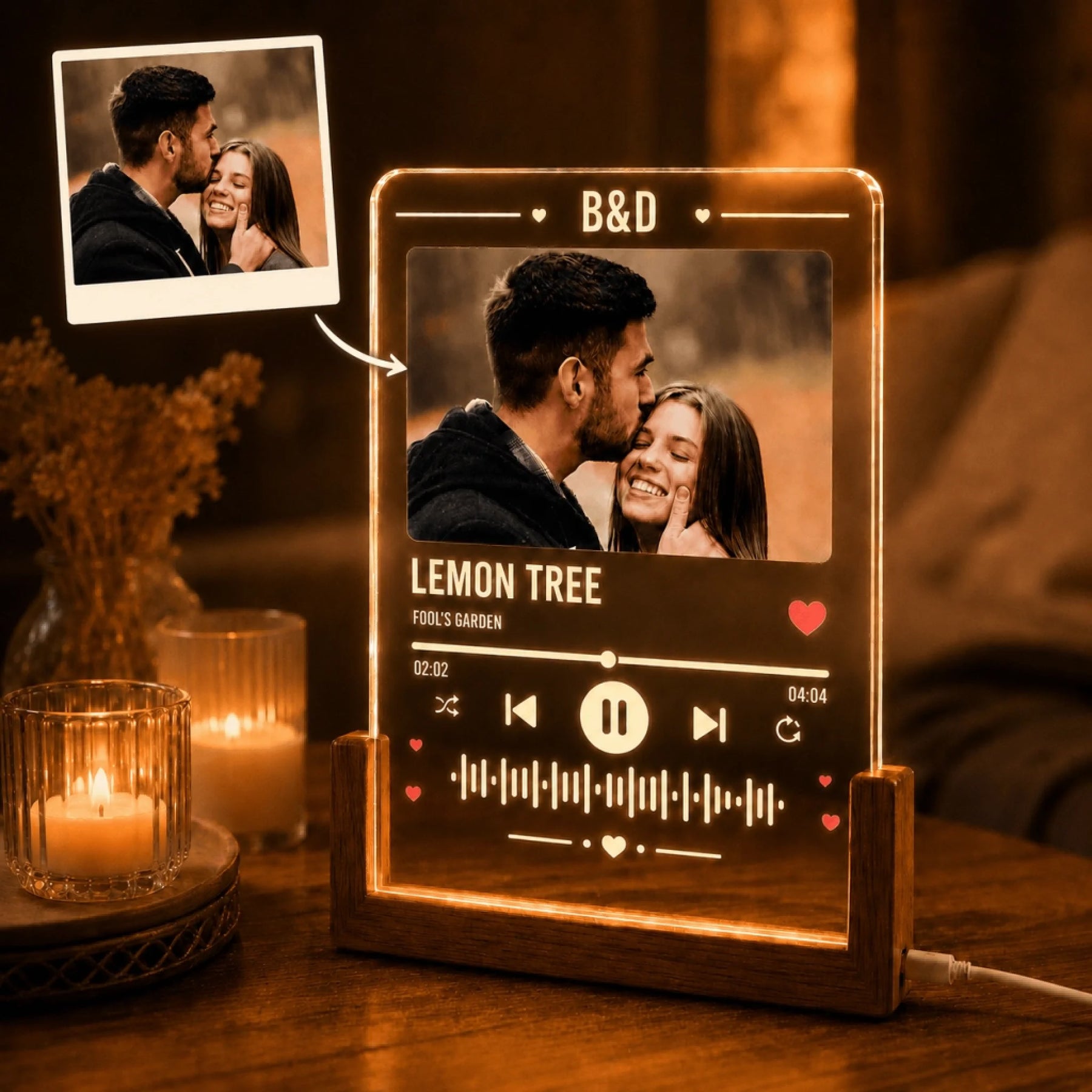 Custom acrylic music plaque featuring a couple's photo, song title, and artist, illuminated in warm light.