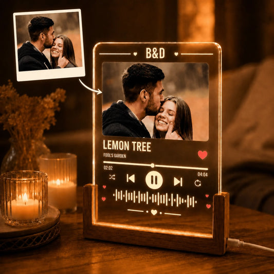 Custom acrylic music plaque featuring a couple's photo, song title, and artist, illuminated in warm light.