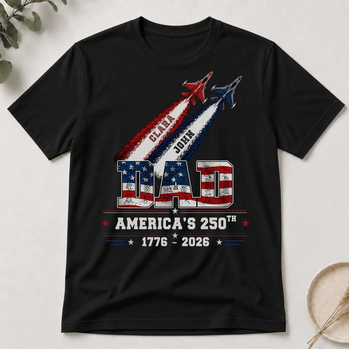 Patriotic dad t-shirt for America 250th anniversary featuring custom names Clara and John with military jet graphics.