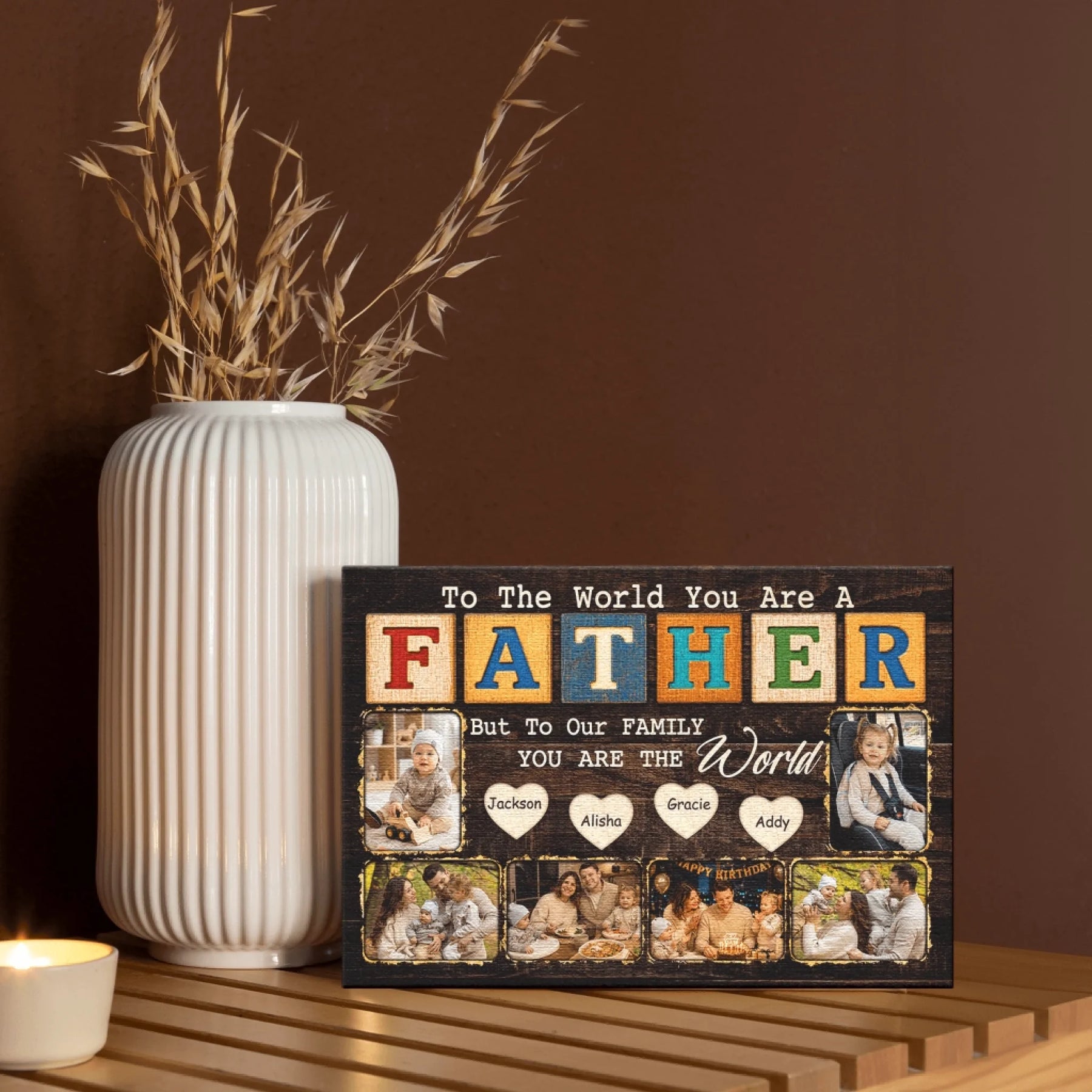 Decorative sign with family photos and text on a wooden surface with a vase and candle in the background.