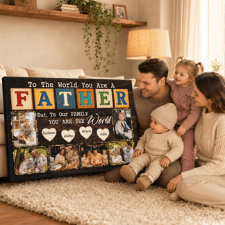 Family sitting on a carpeted floor with a large decorative sign that reads 'To The World You Are A Father, But To Our Family You Are The World'.