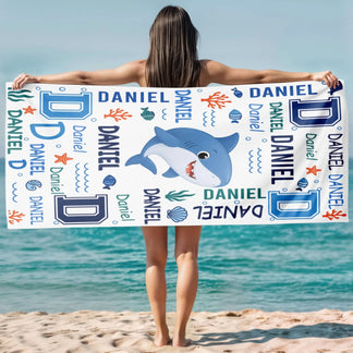 Custom name shark beach towel for kids with blue ocean theme, perfect as a personalized summer birthday beach gift.