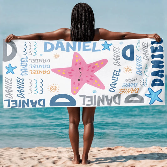 Customized beach towel featuring a cute pink starfish illustration and repeating Daniel name design for beach vacations.