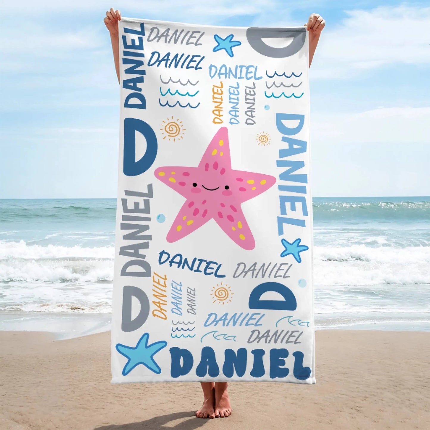 Custom beach towel for kids featuring a cute pink starfish illustration and the name Daniel in colorful typography.