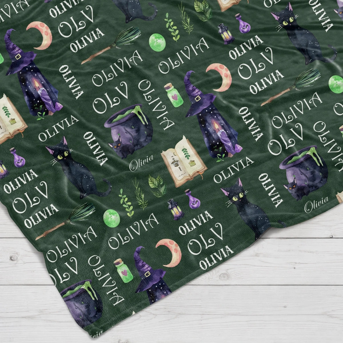 Custom personalized witchy dark green throw blanket featuring black cats and moons for a magical Halloween gift.