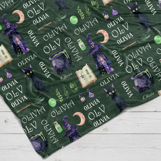 Custom personalized witchy dark green throw blanket featuring black cats and moons for a magical Halloween gift.