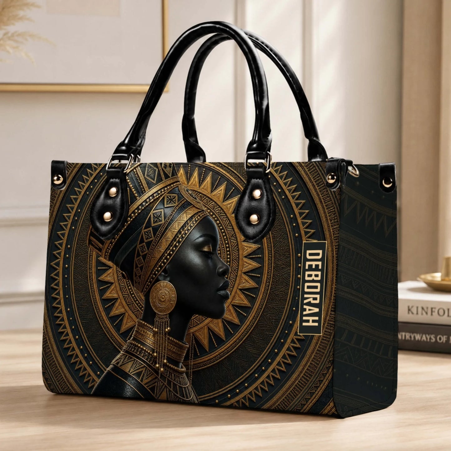 An elegant personalized handbag with African queen artistic print and the custom name Deborah on a desk setting.