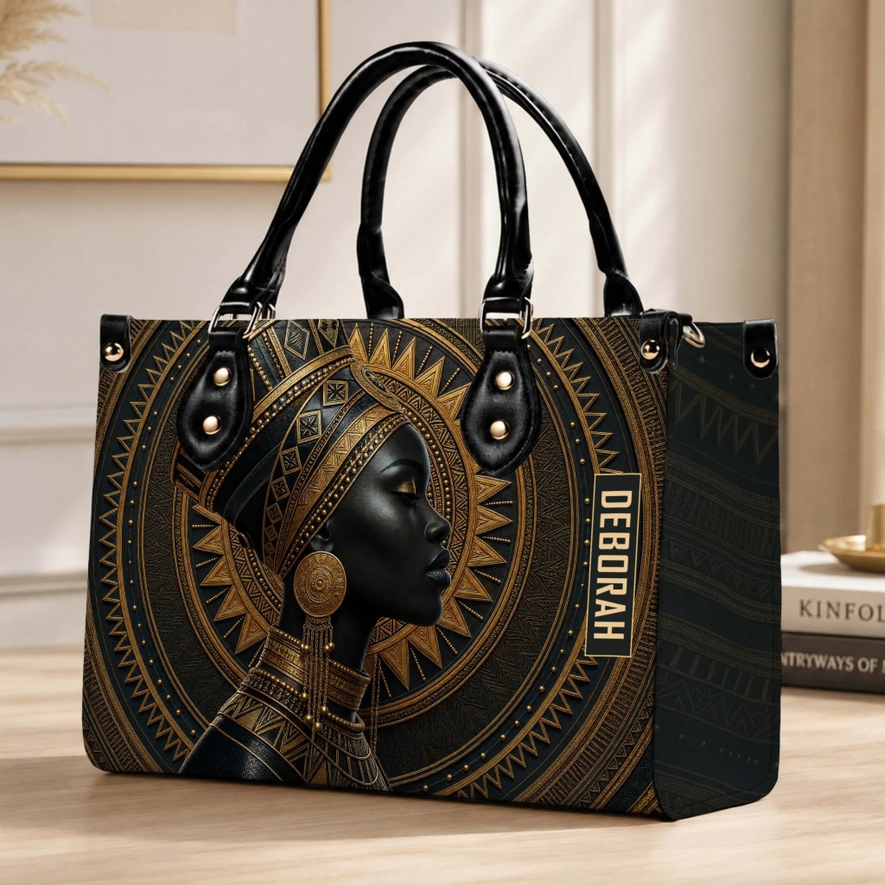 An elegant personalized handbag with African queen artistic print and the custom name Deborah on a desk setting.