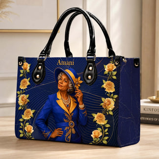Custom Amani handbag featuring an elegant woman in a blue and gold suit surrounded by yellow roses, ideal for birthdays.