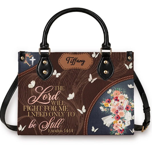 A personalized handbag featuring the bible verse Exodus 14:14 with a cross and floral butterfly design for Tiffany.