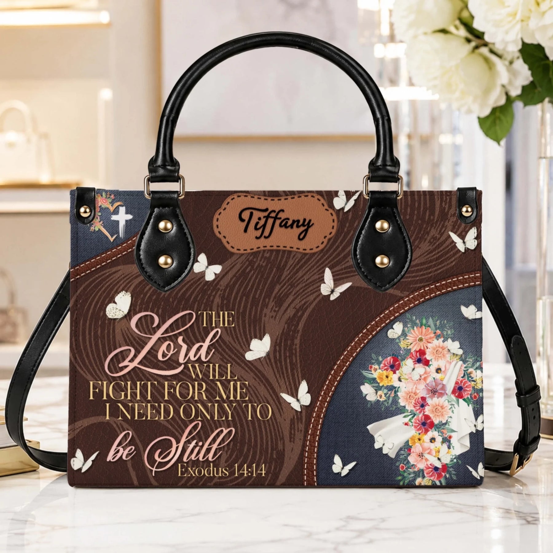 A stylish personalized handbag with Exodus 14:14 verse and a floral cross design on a brown background.