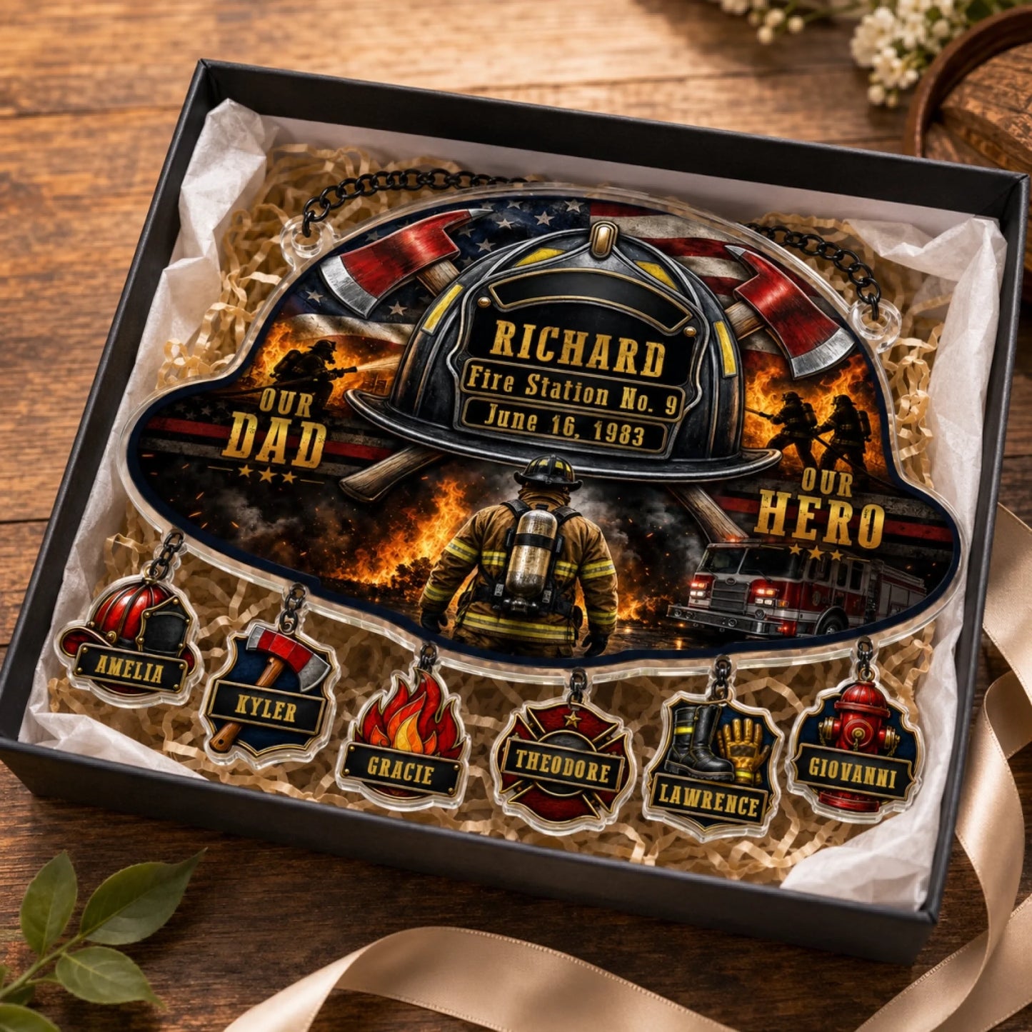 Custom firefighter acrylic ornament for dad inside a gift box, featuring hanging charms with family member names.