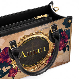 Detailed view of a personalized handbag featuring a custom Amari nameplate with religious cross and floral accents.
