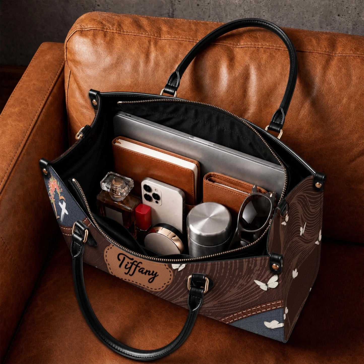 Spacious leather handbag with custom name plate featuring internal pockets for organized storage of daily essentials.