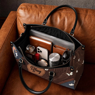 Spacious leather handbag with custom name plate featuring internal pockets for organized storage of daily essentials.