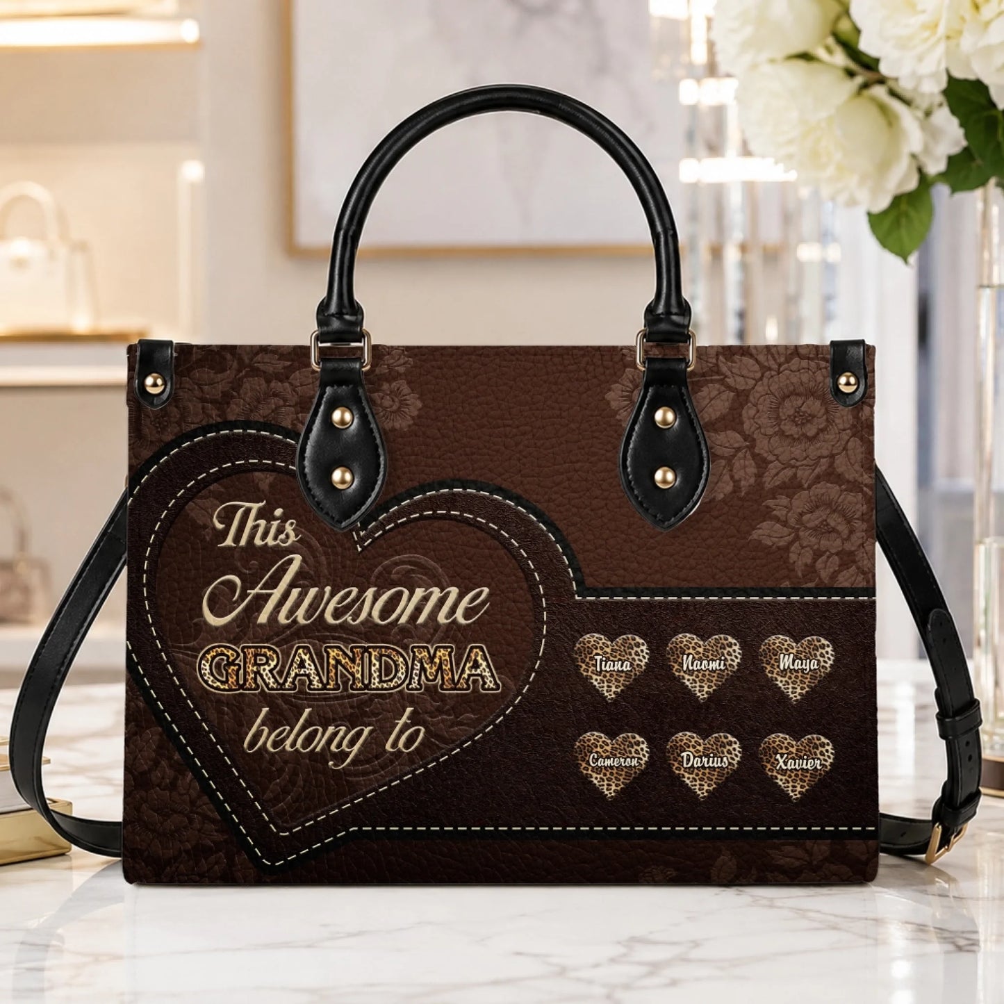 Brown leather handbag for grandma featuring a floral pattern and custom leopard heart graphics with grandchildren names.