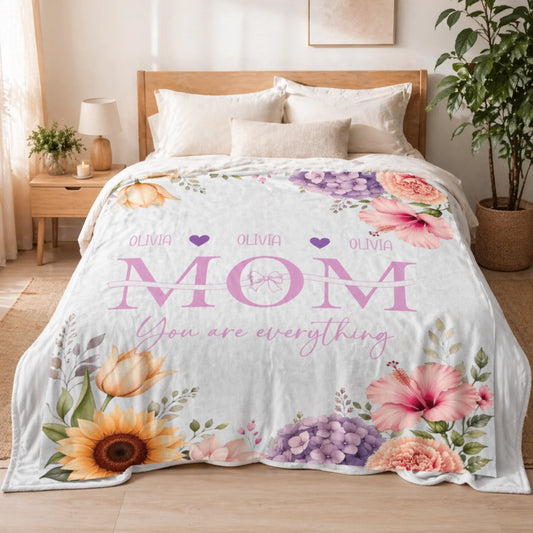 Custom floral throw blanket featuring the name Olivia and Mom You are everything text for a personalized Mother's Day gift.