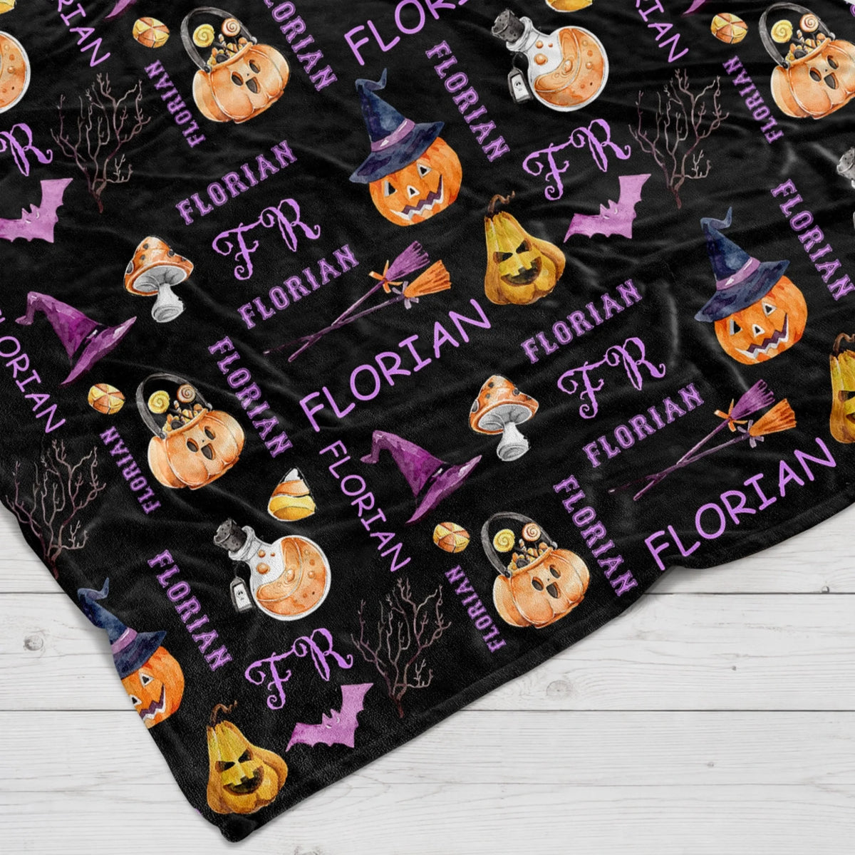 Cozy black fleece blanket featuring a personalized Florian name pattern with watercolor pumpkins witches hats and bats